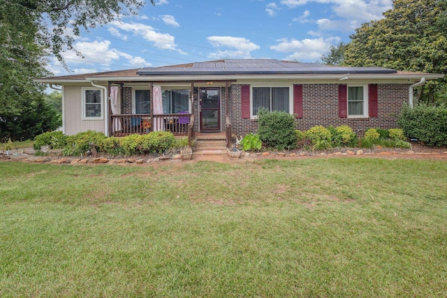 101 Jordan, Lyman, SC 29365 - view of front of property with covered porch, solar panels, a front lawn, and brick siding