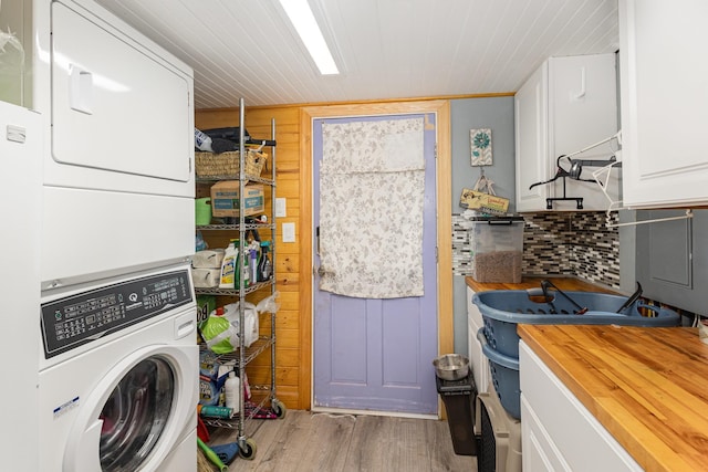 101 Jordan, Lyman, SC 29365 - washroom with stacked washing machine and dryer, wood finished floors, and wooden walls