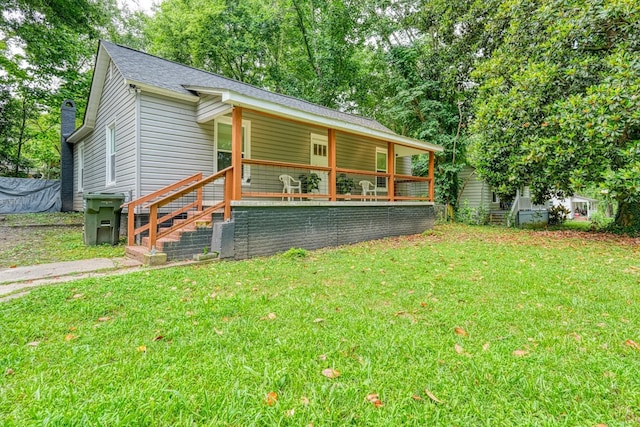 627 Branch, Woodruff, SC 29388 - view of front of home with a front yard, covered porch, a chimney, and a shingled roof