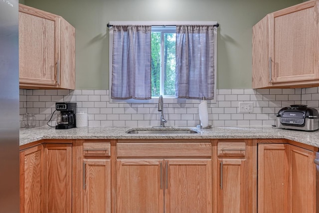627 Branch, Woodruff, SC 29388 - kitchen with stainless steel refrigerator, backsplash, and light stone counters