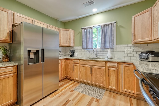 627 Branch, Woodruff, SC 29388 - kitchen with stainless steel appliances, light wood-style floors, backsplash, light stone counters, and recessed lighting