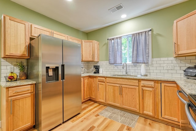 627 Branch, Woodruff, SC 29388 - kitchen featuring stainless steel refrigerator with ice dispenser, decorative backsplash, light wood-style floors, light stone countertops, and recessed lighting