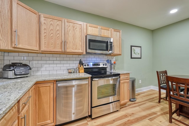 627 Branch, Woodruff, SC 29388 - kitchen with appliances with stainless steel finishes, light brown cabinetry, light wood-style flooring, backsplash, and recessed lighting