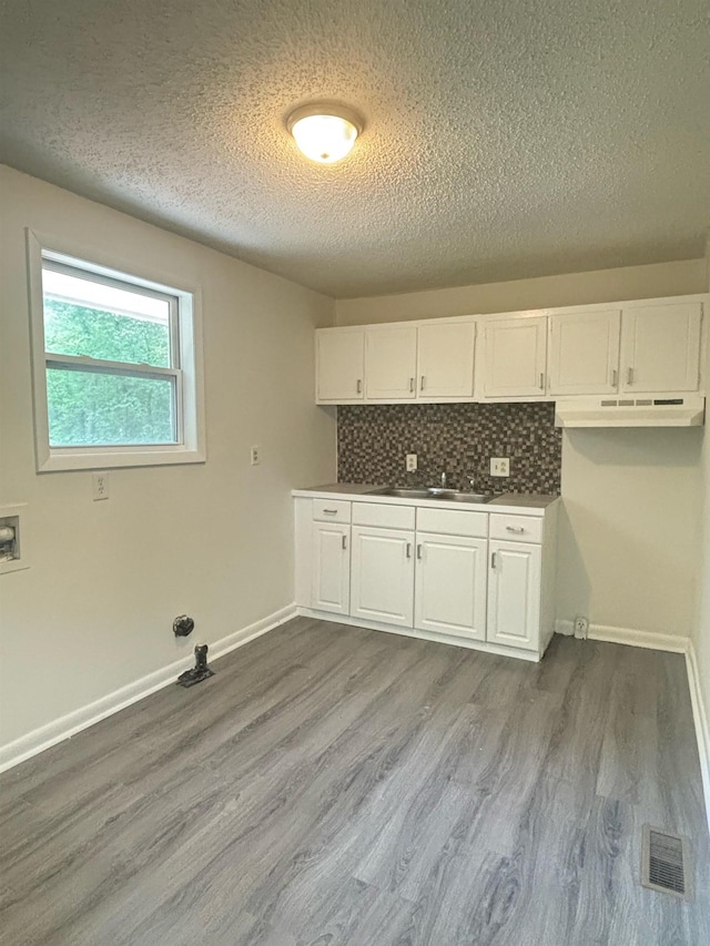 121 Hillside Dr, Spartanburg, SC 29303 - laundry area featuring a textured ceiling, dark wood-type flooring, hookup for a washing machine, cabinet space, and gas dryer hookup