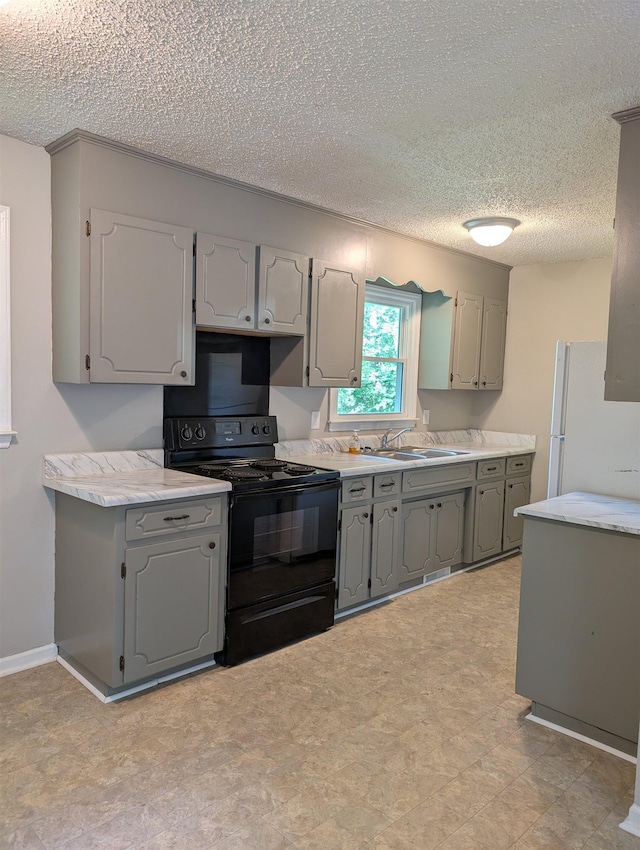 126 Loblolly, Wellford, SC 29385 - kitchen with black range with electric cooktop, freestanding refrigerator, gray cabinets, a textured ceiling, and light countertops