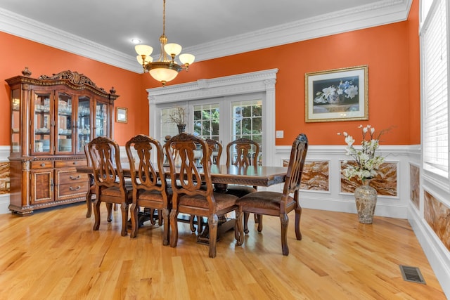 410 Anchorage, Inman, SC 29349 - dining space with a chandelier, ornamental molding, light wood-style flooring, and a wainscoted wall