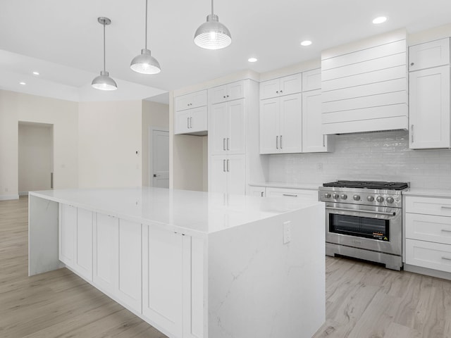 162 Clearcreek, Boiling Springs, SC 29316 - kitchen featuring high end stove, premium range hood, light wood finished floors, recessed lighting, and white cabinetry