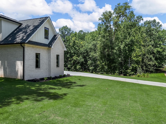 162 Clearcreek, Boiling Springs, SC 29316 - view of property exterior featuring board and batten siding, brick siding, a lawn, and roof with shingles