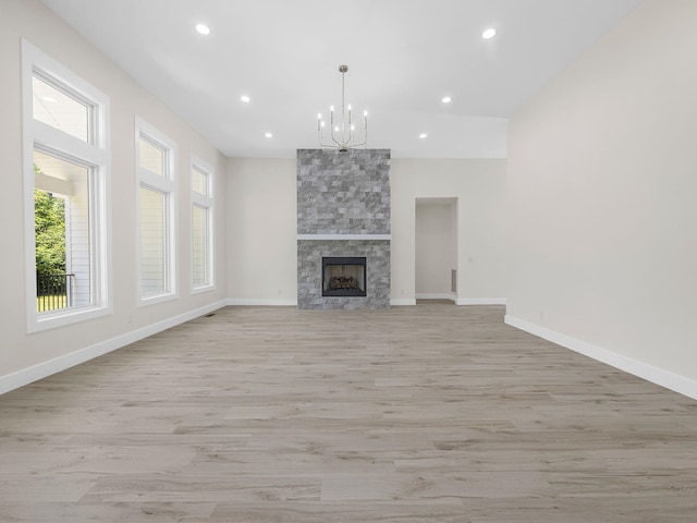 162 Clearcreek, Boiling Springs, SC 29316 - unfurnished living room with light wood-style flooring, a chandelier, recessed lighting, and a large fireplace