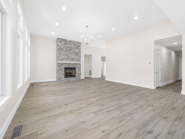 162 Clearcreek, Boiling Springs, SC 29316 - unfurnished living room with light wood-style flooring, a chandelier, recessed lighting, and a fireplace