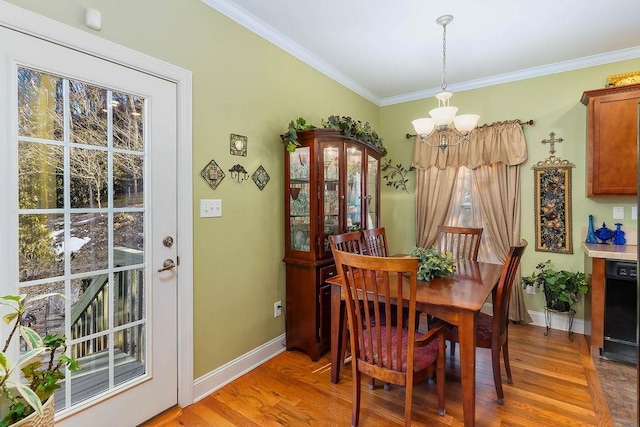 387 Goodview, Hendersonville, NC 28792 - dining room featuring a chandelier, light wood-type flooring, and ornamental molding