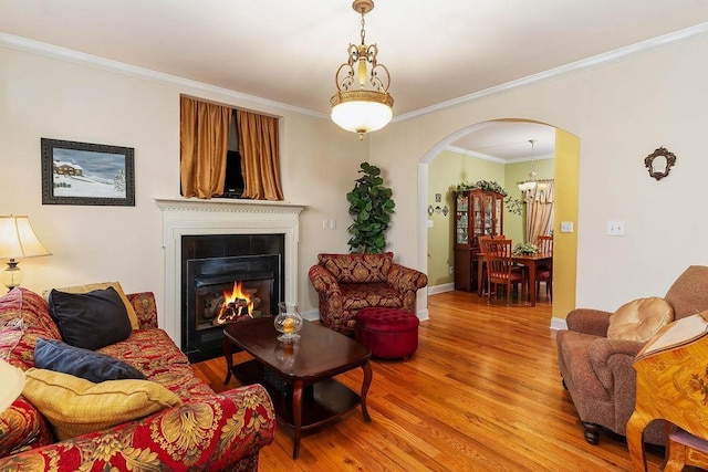 387 Goodview, Hendersonville, NC 28792 - living room with arched walkways, light wood-style flooring, ornamental molding, and a large fireplace