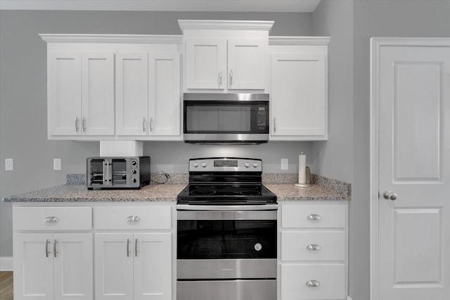 826 Chartwell, Greer, SC 29650 - kitchen with stainless steel appliances, white cabinets, and light stone countertops
