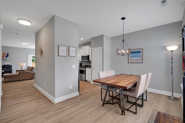826 Chartwell, Greer, SC 29650 - dining area with light wood-style flooring and a chandelier