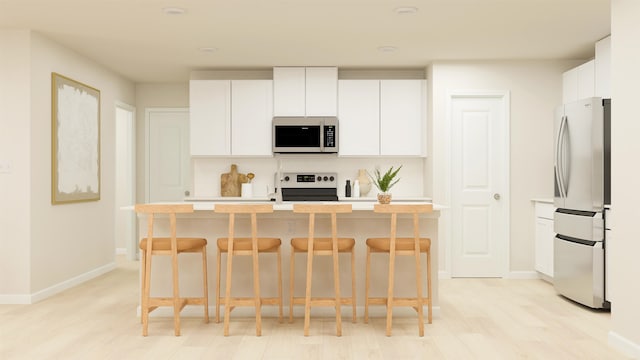 1079 Cleveland Mdws, Spartanburg, SC 29303 - kitchen with white microwave, freestanding refrigerator, range with electric stovetop, and light countertops