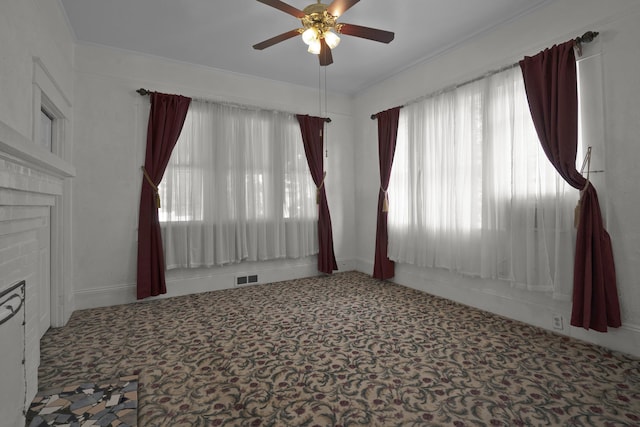 283 Hydrick, Spartanburg, SC 29306 - carpeted spare room with ceiling fan, a brick fireplace, and crown molding