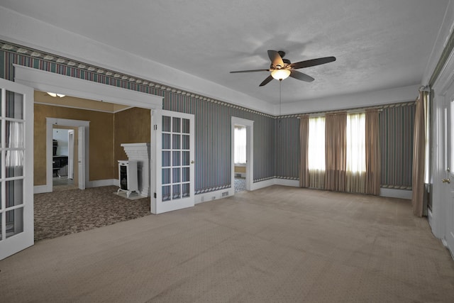 283 Hydrick, Spartanburg, SC 29306 - carpeted empty room with a ceiling fan, french doors, a textured ceiling, and a fireplace