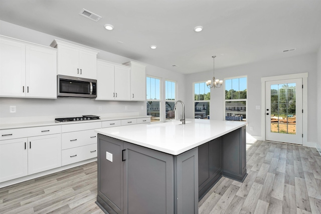 913 Wild Pne, Duncan, SC 29334 - kitchen featuring stainless steel microwave, light wood finished floors, white cabinets, light countertops, and recessed lighting