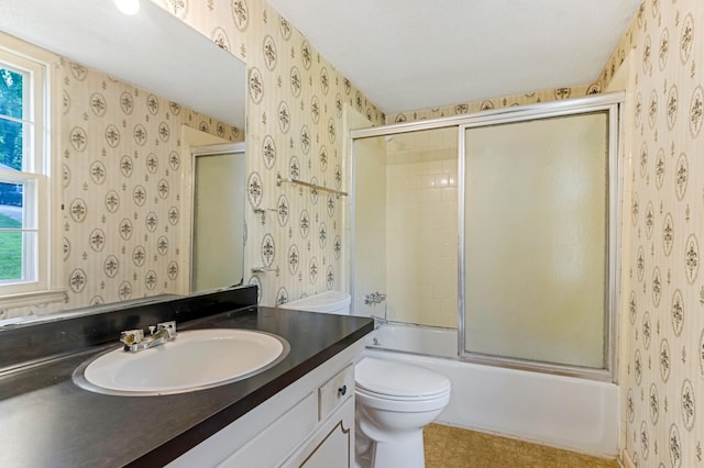 207 Oakmont Dr, Spartanburg, SC 29316 - bathroom featuring wallpapered walls, vanity, and bath / shower combo with glass door