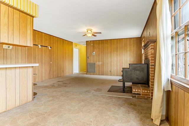 207 Oakmont Dr, Spartanburg, SC 29316 - unfurnished living room featuring stone floors, wood walls, and a ceiling fan