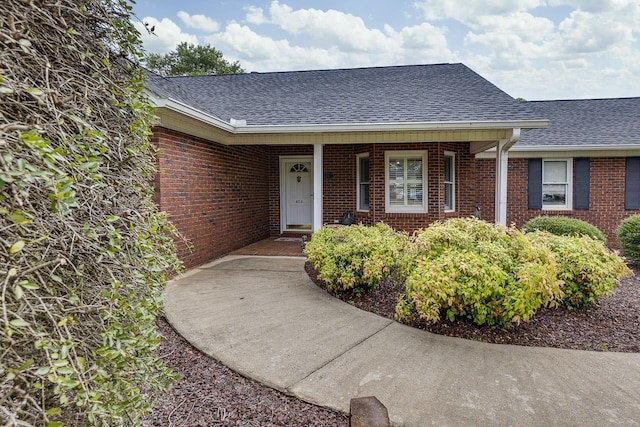 409 Cresthaven, Boiling Springs, SC 29316 - view of exterior entry featuring a shingled roof, brick siding, and covered porch