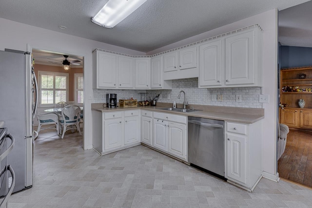 409 Cresthaven, Boiling Springs, SC 29316 - kitchen with appliances with stainless steel finishes, ceiling fan, white cabinets, backsplash, and a textured ceiling