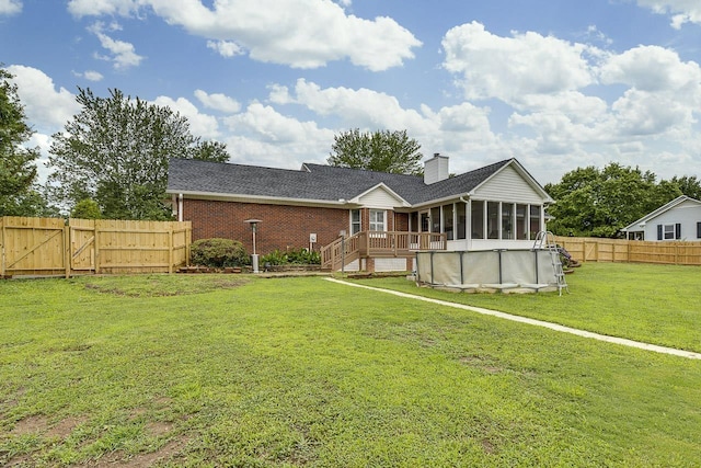 409 Cresthaven, Boiling Springs, SC 29316 - back of house featuring a sunroom, a fenced backyard, a gate, a chimney, and brick siding