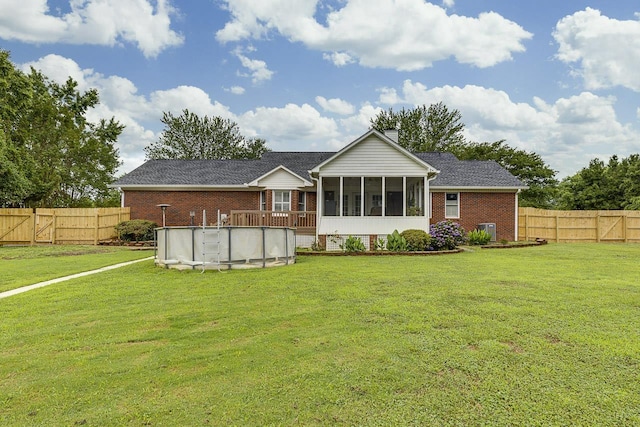 409 Cresthaven, Boiling Springs, SC 29316 - rear view of property with a sunroom, brick siding, an outdoor pool, a fenced backyard, and a chimney