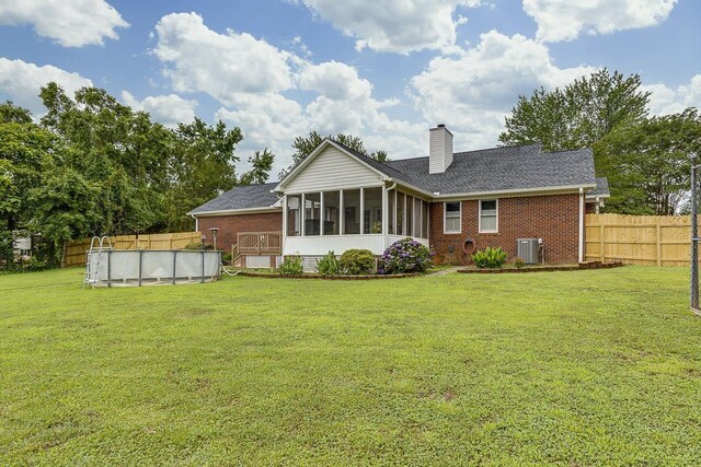 409 Cresthaven, Boiling Springs, SC 29316 - rear view of property with a sunroom, brick siding, and a chimney