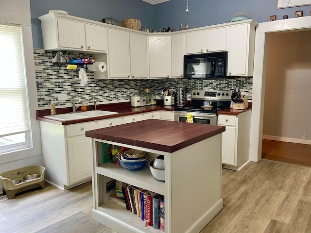 511 El Bethel Rd, Gaffney, SC 29340 - kitchen featuring black microwave, stainless steel range with electric stovetop, butcher block countertops, open shelves, and light wood-style flooring