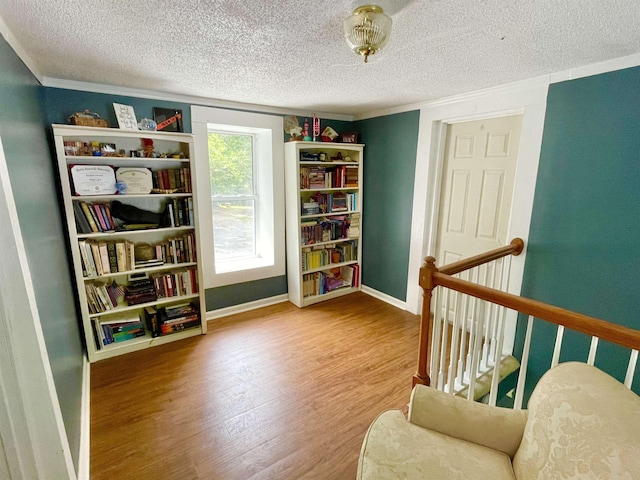 511 El Bethel Rd, Gaffney, SC 29340 - living area featuring wood finished floors, a textured ceiling, ornamental molding, and an upstairs landing