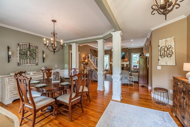 228 Antrim, Moore, SC 29369 - dining room featuring a chandelier, crown molding, decorative columns, light wood-style flooring, and stairs