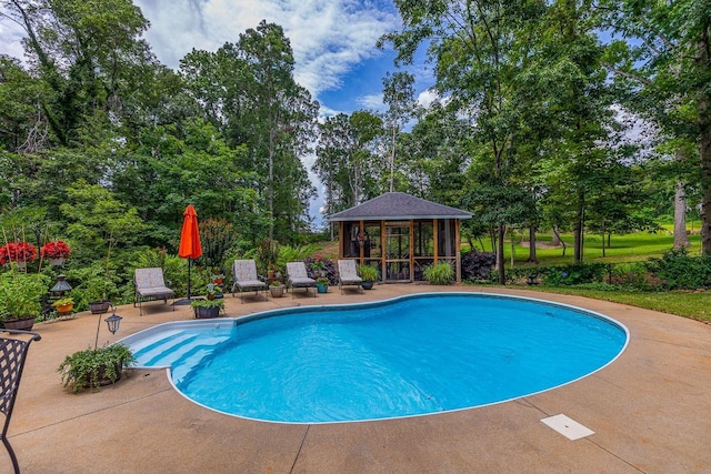 228 Antrim, Moore, SC 29369 - outdoor pool with a patio, view of wooded area, an outbuilding, and an exterior structure