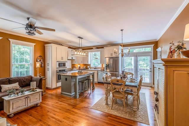 228 Antrim, Moore, SC 29369 - kitchen featuring stainless steel appliances, ornamental molding, healthy amount of natural light, a kitchen bar, and a kitchen island