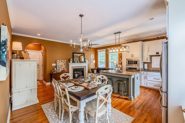 228 Antrim, Moore, SC 29369 - dining room featuring arched walkways, ornamental molding, light wood-style flooring, a chandelier, and recessed lighting