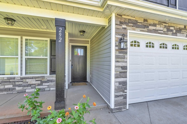 292 Long Br, Chesnee, SC 29323 - property entrance with stone siding, a garage, and a porch