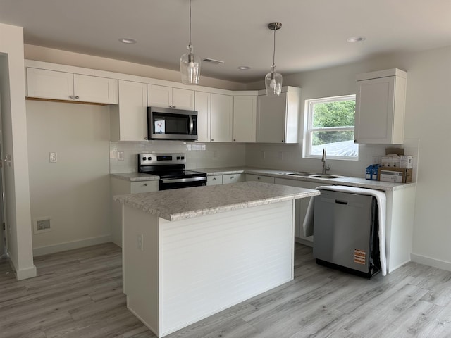 189 Ohio, Chesnee, SC 29323 - kitchen featuring appliances with stainless steel finishes, light wood-style flooring, decorative backsplash, white cabinetry, and recessed lighting