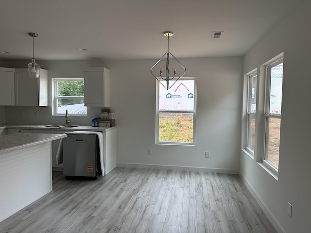 189 Ohio, Chesnee, SC 29323 - kitchen with light countertops, light wood finished floors, white cabinetry, decorative backsplash, and decorative light fixtures