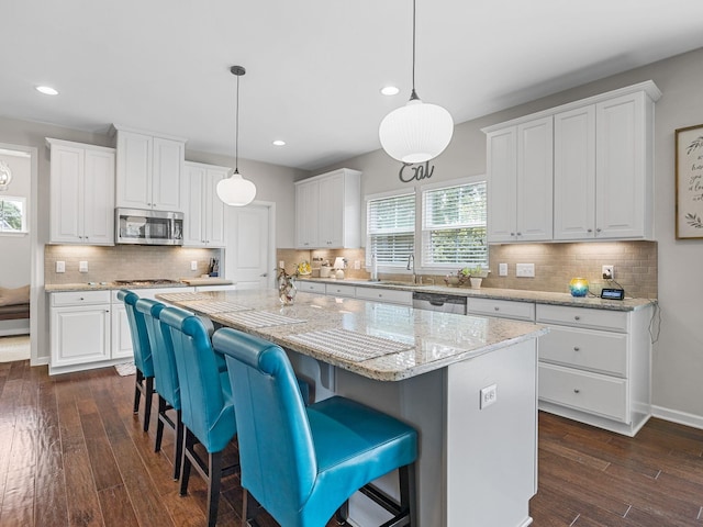 711 Hatwood, Duncan, SC 29334 - kitchen with appliances with stainless steel finishes, a kitchen island, white cabinets, recessed lighting, and dark wood-type flooring