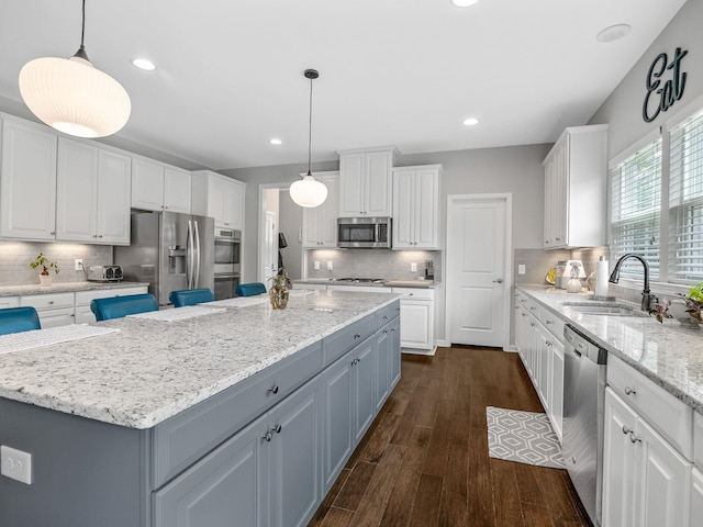 711 Hatwood, Duncan, SC 29334 - kitchen featuring appliances with stainless steel finishes, white cabinets, a kitchen island, tasteful backsplash, and recessed lighting