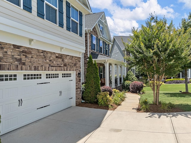 711 Hatwood, Duncan, SC 29334 - view of side of property with stone siding, a lawn, a garage, and concrete driveway