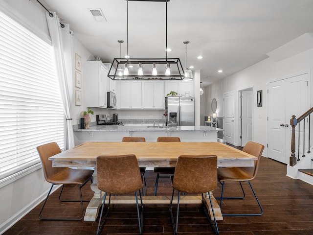 244 Cassingham, Boiling Springs, SC 29316 - kitchen featuring stainless steel appliances, dark wood-style floors, a peninsula, white cabinetry, and decorative light fixtures