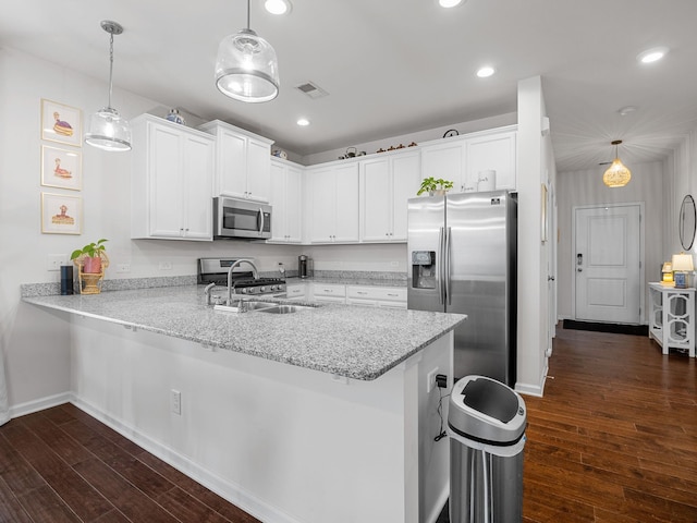 244 Cassingham, Boiling Springs, SC 29316 - kitchen featuring stainless steel appliances, a peninsula, white cabinets, dark wood-style floors, and hanging light fixtures