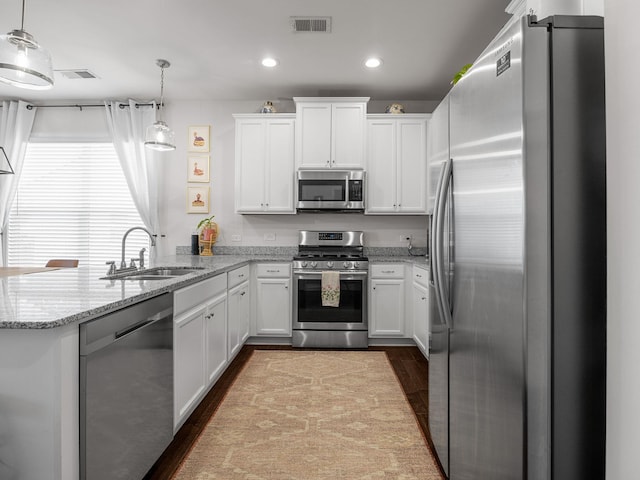 244 Cassingham, Boiling Springs, SC 29316 - kitchen with stainless steel appliances, a peninsula, white cabinets, dark wood finished floors, and recessed lighting