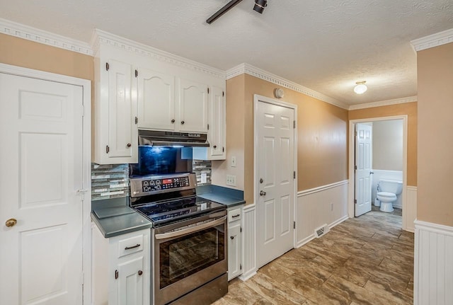 215 E Shefford, Greer, SC 29650 - kitchen with stainless steel electric range oven, under cabinet range hood, white cabinets, a textured ceiling, and a wainscoted wall