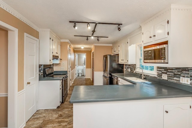 215 E Shefford, Greer, SC 29650 - kitchen featuring appliances with stainless steel finishes, dark countertops, decorative backsplash, white cabinets, and crown molding