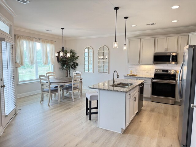 2601 Karkinnen, Moore, SC 29369 - kitchen with appliances with stainless steel finishes, ornamental molding, healthy amount of natural light, light wood-type flooring, and recessed lighting