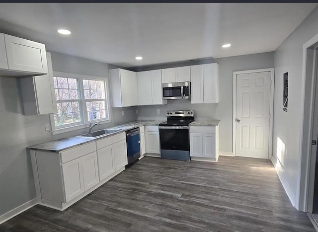 1547 Farley Ave, Spartanburg, SC 29306 - kitchen with appliances with stainless steel finishes, white cabinets, dark wood-style floors, light countertops, and recessed lighting