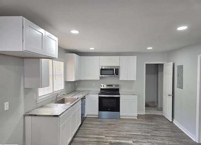 1547 Farley Ave, Spartanburg, SC 29306 - kitchen featuring stainless steel appliances, wood finished floors, white cabinets, recessed lighting, and light countertops