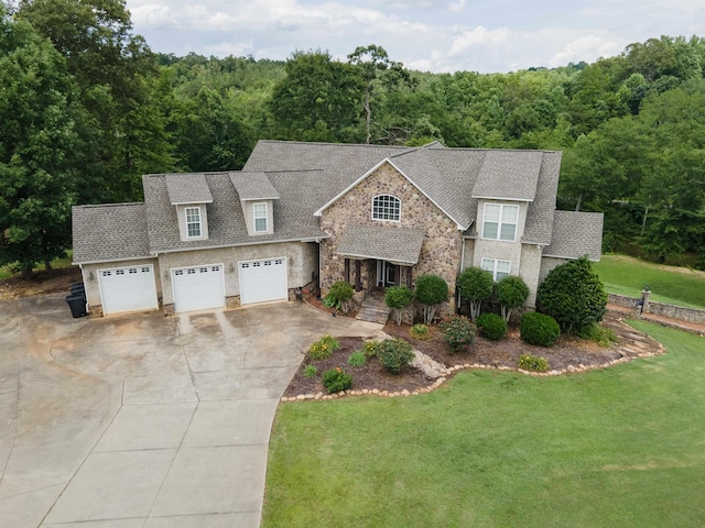 2650 Rainbow Lake Rd, Inman, SC 29349 - view of front of home with driveway, stone siding, a front lawn, a view of trees, and a garage